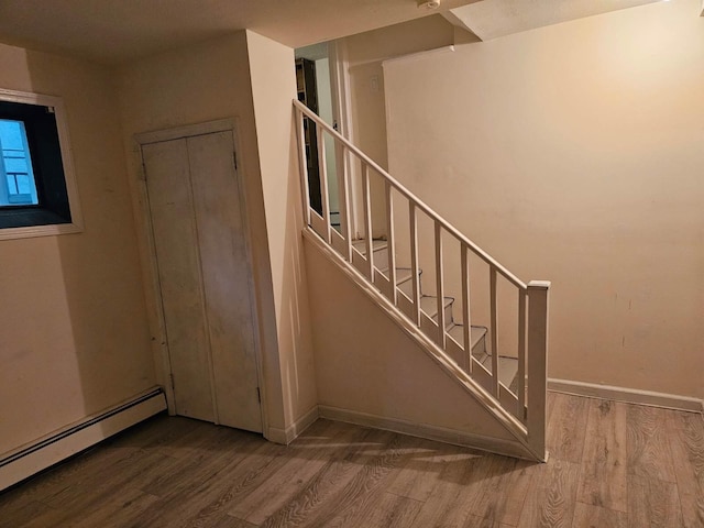 23 Beverly Rd, Glen Cove, NY 11542 - stairway with a baseboard heating unit, wood finished floors, and baseboards