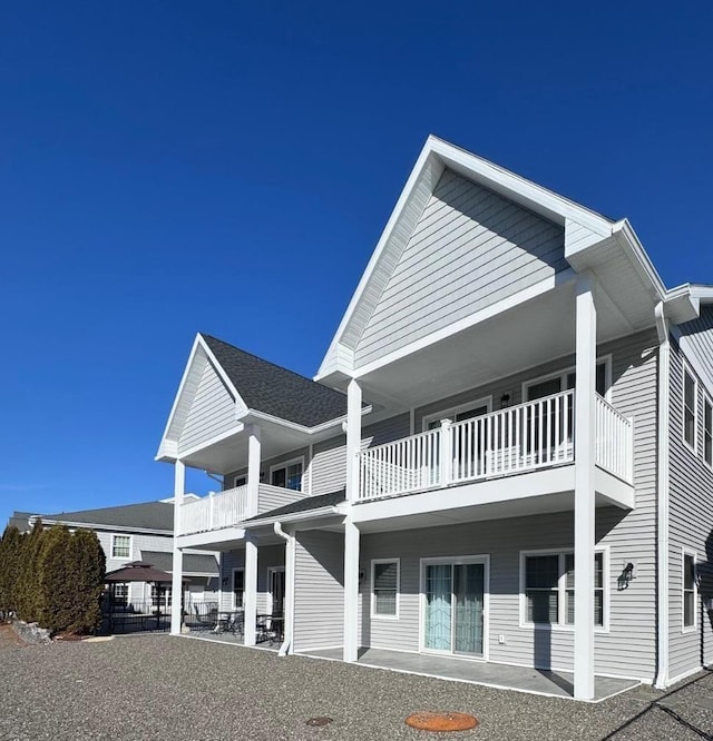 view of side of home featuring a balcony