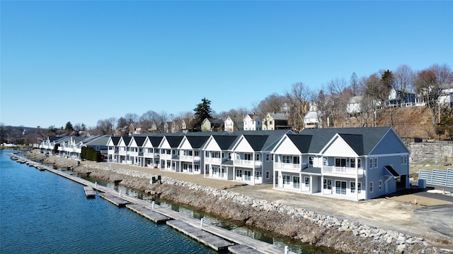bird's eye view with a water view and a residential view