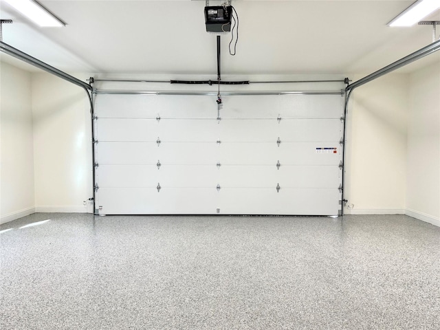 garage with baseboards and a garage door opener