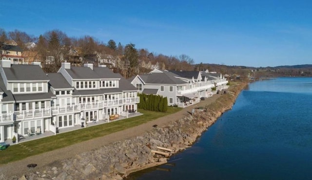 birds eye view of property featuring a water view and a residential view