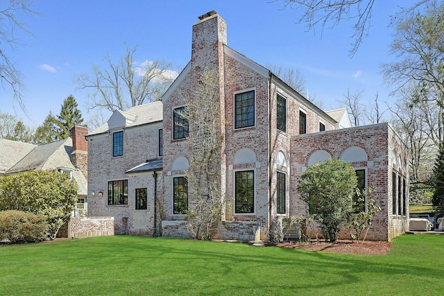 165 Valley Rd, New Rochelle, NY 10804 - exterior space with brick siding, a chimney, and a lawn
