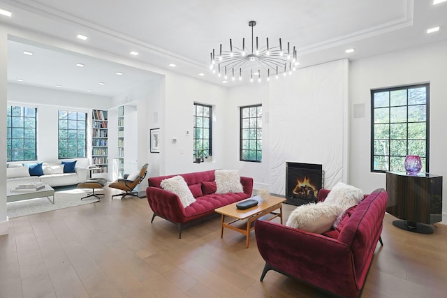 165 Valley Rd, New Rochelle, NY 10804 - living room featuring a tray ceiling, recessed lighting, a chandelier, wood finished floors, and a high end fireplace