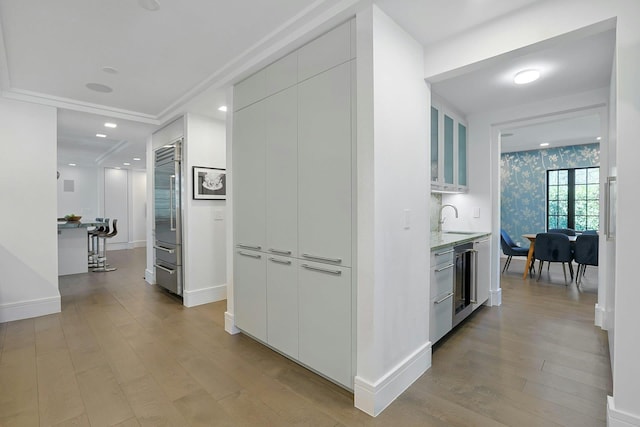 165 Valley Rd, New Rochelle, NY 10804 - corridor featuring wallpapered walls, light wood-style flooring, baseboards, and a sink