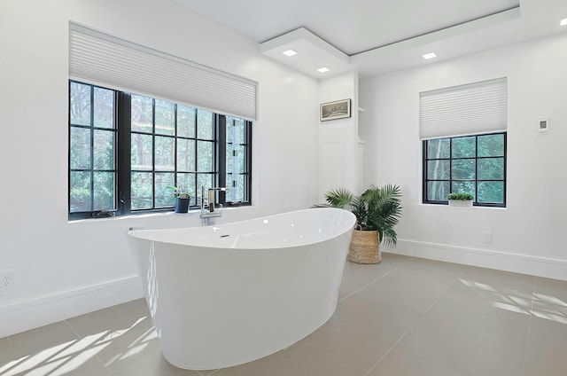 165 Valley Rd, New Rochelle, NY 10804 - full bath with tile patterned floors, a freestanding bath, plenty of natural light, and baseboards