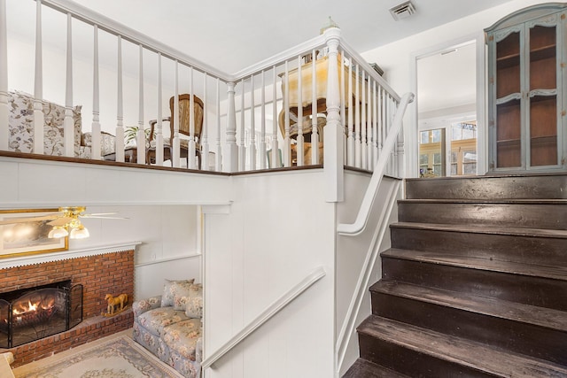 927 Mica Ct, Valley Cottage, NY 10989 - stairs with ceiling fan, a brick fireplace, and visible vents