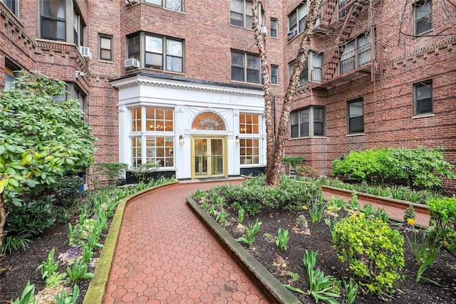 entrance to property featuring brick siding and french doors