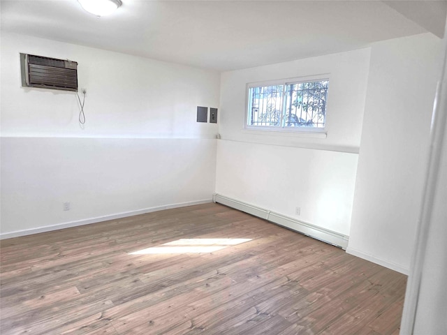134-15 160th St, Jamaica, NY 11434 - spare room with baseboard heating, wood finished floors, and baseboards