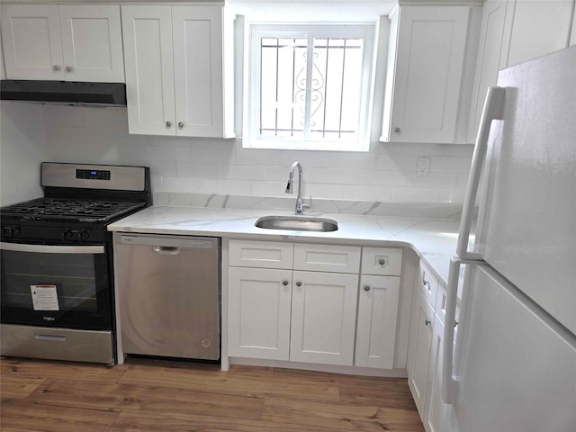 134-15 160th St, Jamaica, NY 11434 - kitchen featuring stainless steel appliances, a sink, under cabinet range hood, and white cabinetry