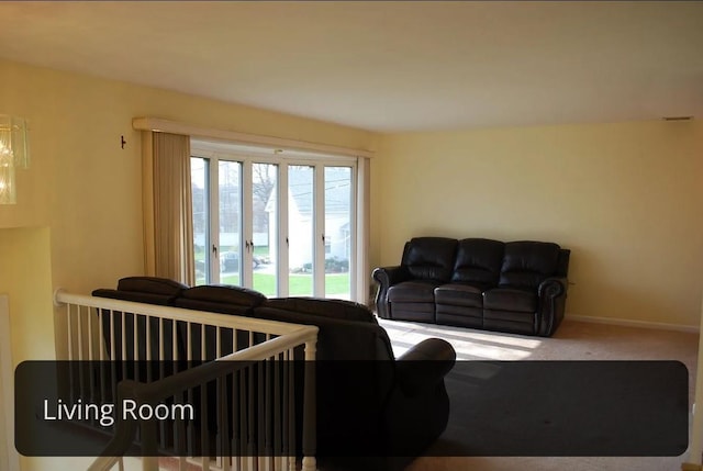 carpeted living room featuring baseboards