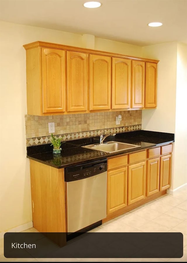 kitchen featuring a sink, backsplash, dishwasher, and light brown cabinets