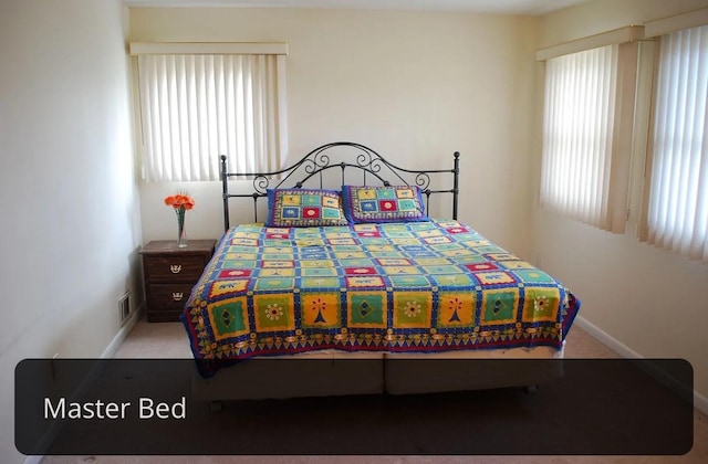 bedroom with baseboards, visible vents, and carpet floors