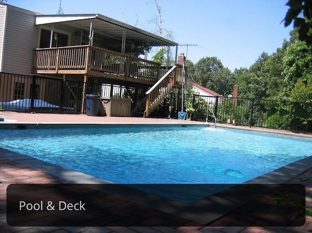 view of pool featuring a wooden deck, a fenced in pool, fence, and stairway