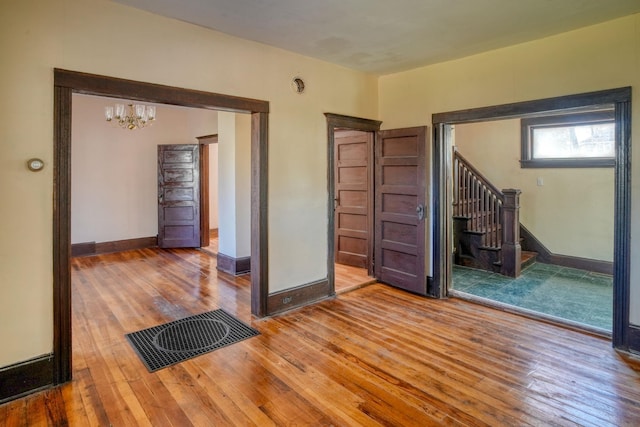 58 Summitville Rd, Wurtsboro, NY 12790 - empty room with baseboards, an inviting chandelier, stairs, visible vents, and wood-type flooring
