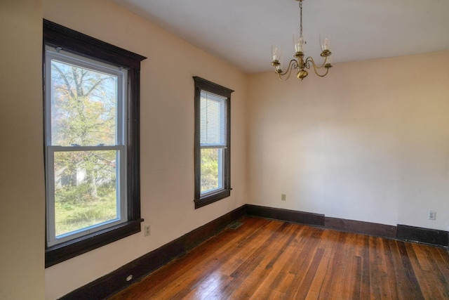 58 Summitville Rd, Wurtsboro, NY 12790 - spare room featuring a notable chandelier, dark wood-style flooring, baseboards, and visible vents