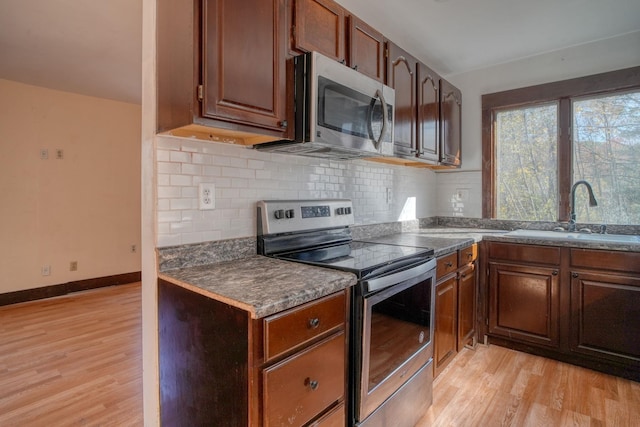 58 Summitville Rd, Wurtsboro, NY 12790 - kitchen featuring a sink, tasteful backsplash, appliances with stainless steel finishes, and light wood finished floors
