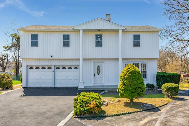 38 Melody Ln, Amityville, NY 11701 - colonial inspired home with an attached garage and aphalt driveway