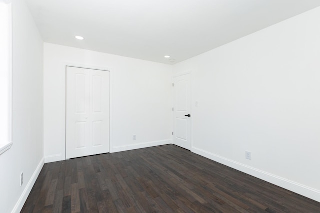 38 Melody Ln, Amityville, NY 11701 - unfurnished bedroom featuring a closet, baseboards, dark wood-style floors, and recessed lighting