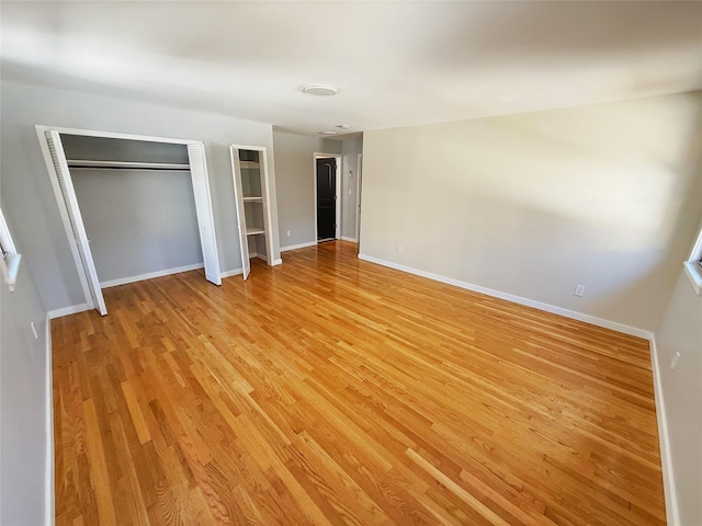 unfurnished bedroom featuring baseboards and light wood finished floors
