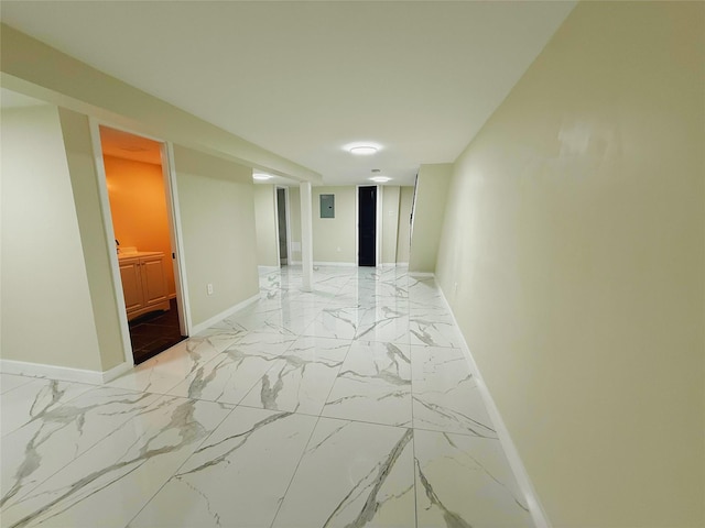 corridor with marble finish floor and baseboards