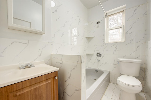 full bath with vanity, tile walls, toilet, bathtub / shower combination, and marble finish floor