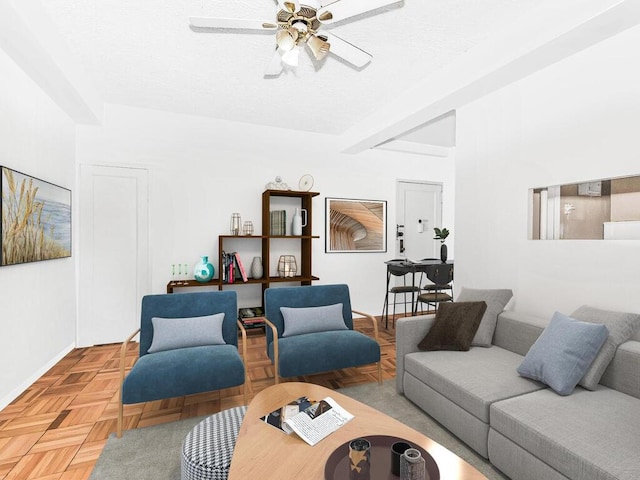living area with a textured ceiling, baseboards, beam ceiling, and ceiling fan