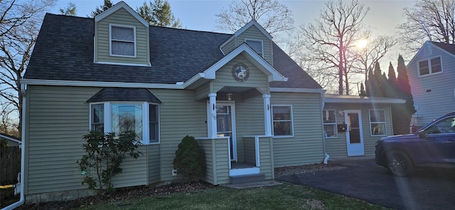 view of front of property featuring roof with shingles
