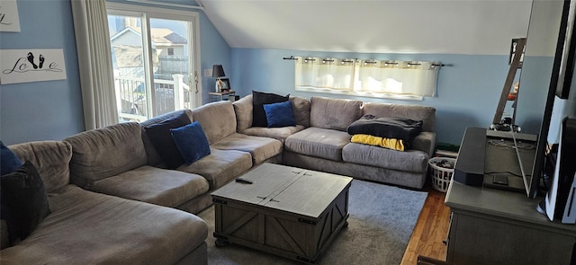living area featuring vaulted ceiling and wood finished floors