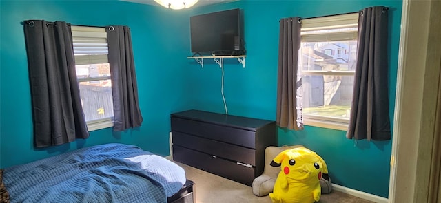 bedroom featuring carpet floors and multiple windows