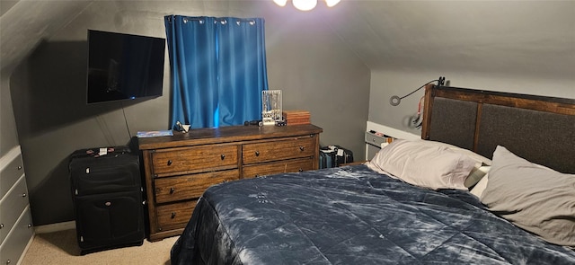 bedroom with carpet floors and vaulted ceiling