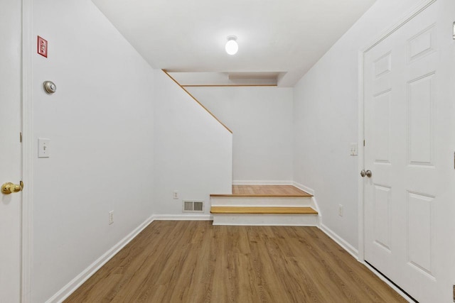 empty room featuring wood finished floors and baseboards