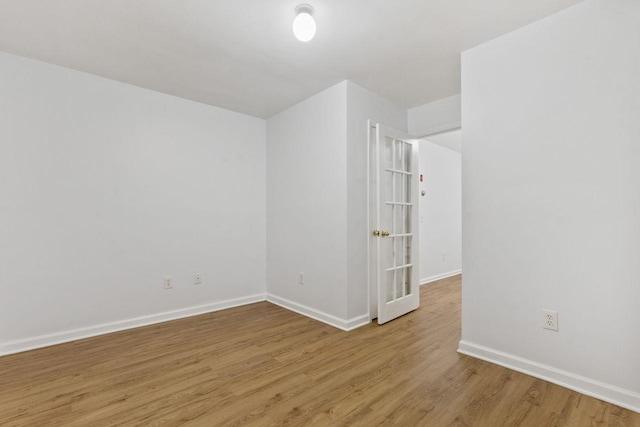 unfurnished room featuring light wood-style floors and baseboards