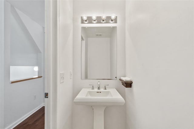 bathroom featuring wood finished floors and baseboards