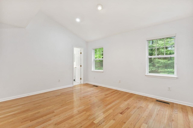 unfurnished room with baseboards, lofted ceiling, light wood finished floors, and recessed lighting