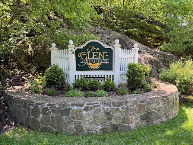 community / neighborhood sign with fence