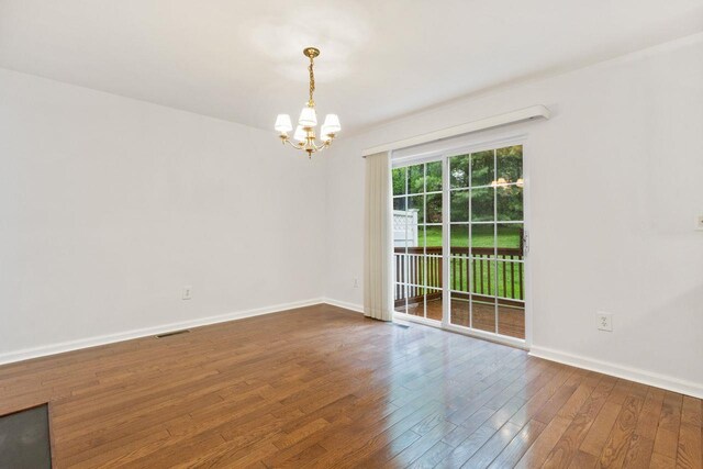 123 Park Rd Extension, Goldens Bridge, NY 10526 - empty room with a chandelier, hardwood / wood-style flooring, and baseboards