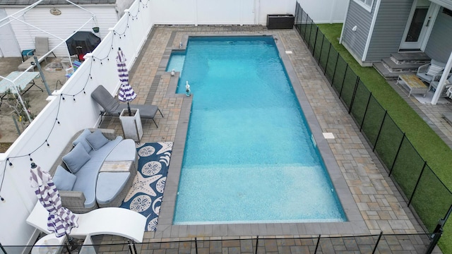 view of pool featuring a fenced backyard, a fenced in pool, and a grill