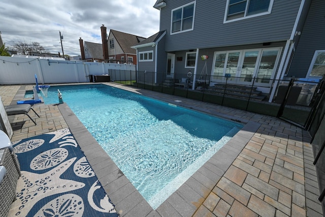 view of swimming pool featuring a fenced backyard, a patio, and a fenced in pool