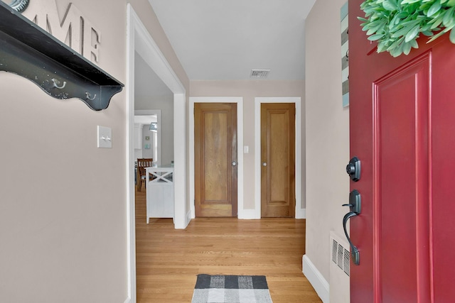 entryway featuring baseboards, visible vents, and light wood-type flooring