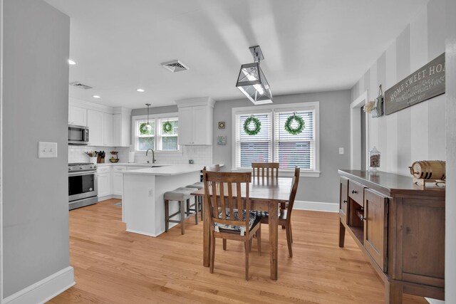 dining space with visible vents, recessed lighting, light wood finished floors, and baseboards