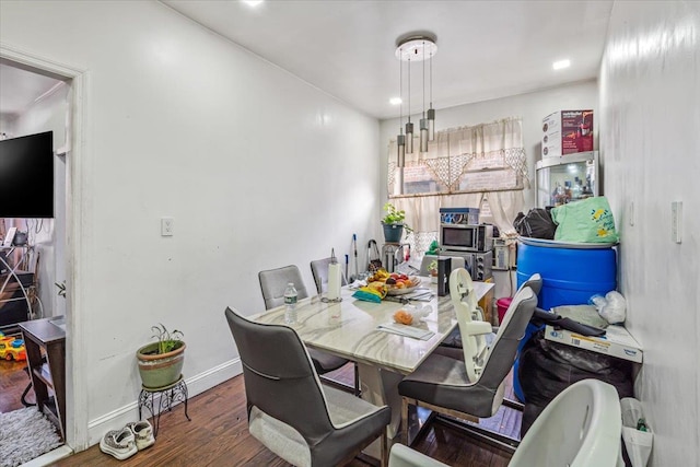 dining room featuring wood finished floors and baseboards