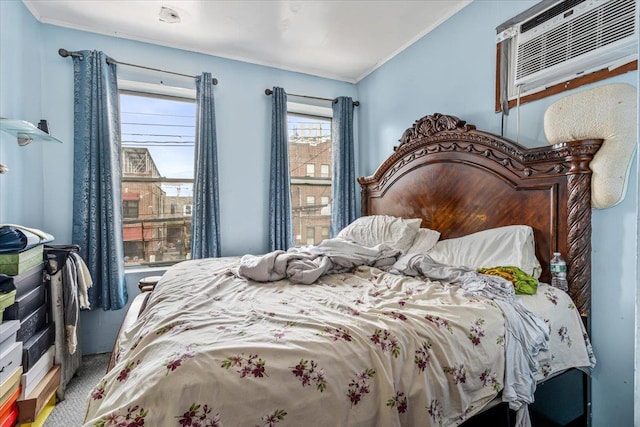 bedroom with a wall unit AC, ornamental molding, and carpet
