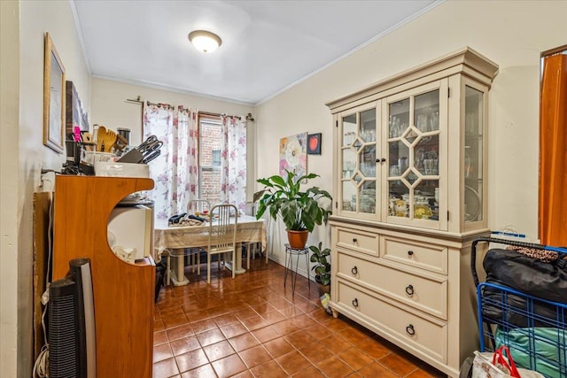 sitting room with crown molding and tile patterned flooring