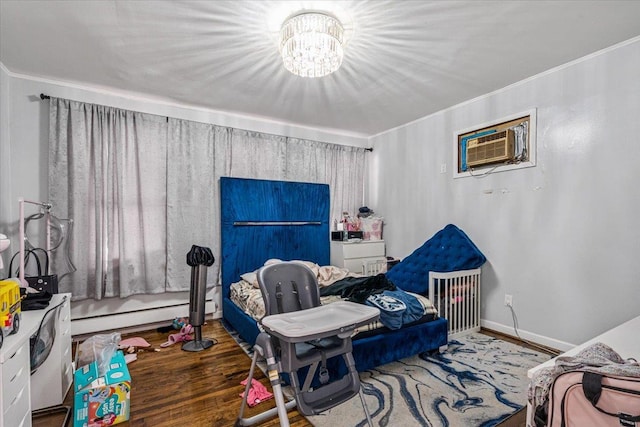 bedroom featuring wood finished floors, a wall mounted air conditioner, a chandelier, and crown molding