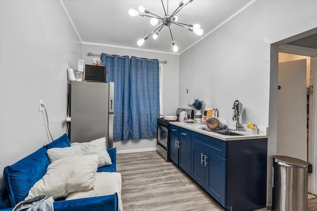 interior space featuring blue cabinets, stainless steel appliances, a notable chandelier, and ornamental molding