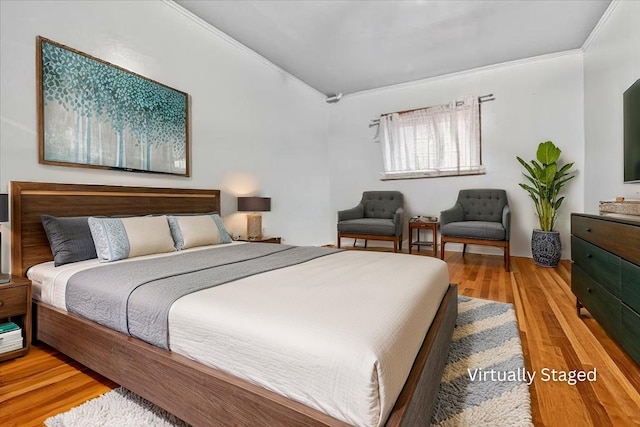 bedroom featuring lofted ceiling and wood finished floors
