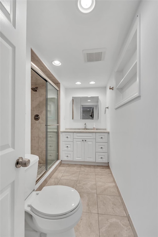 bathroom with a shower stall, vanity, recessed lighting, toilet, and baseboards