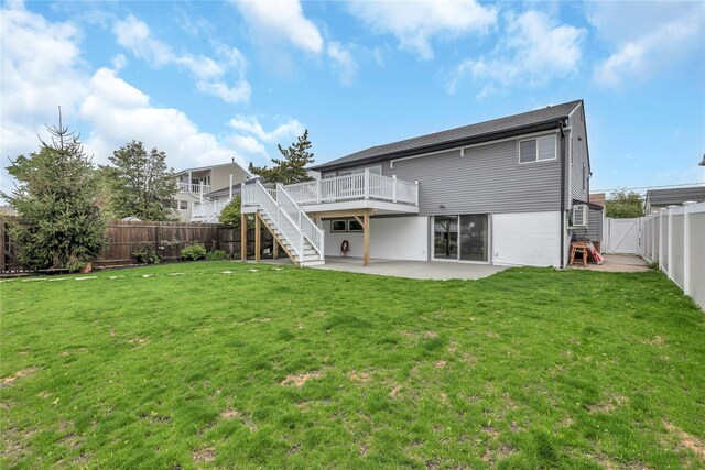 rear view of property featuring stairs, a patio area, and a wooden deck