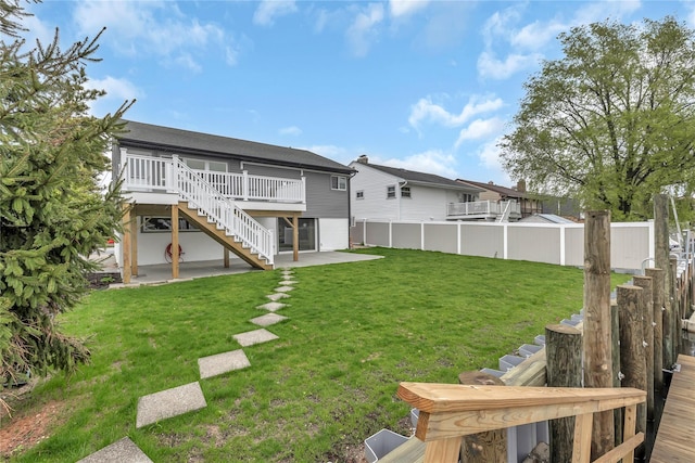 view of yard featuring stairs, a patio, and a wooden deck