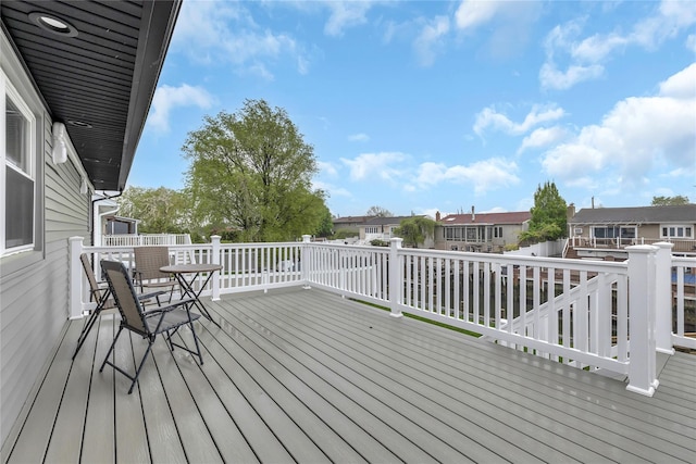 wooden terrace with a residential view